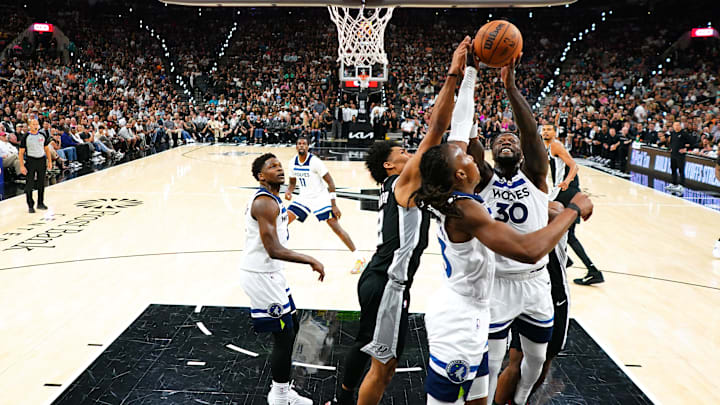 May 12, 2026; San Antonio, Texas, USA; Minnesota Timberwolves forward Julius Randle (30) and guard Ayo Dosunmu (13) reach for a rebound ahead of San Antonio Spurs guard Dylan Harper (2) during the first half of game five of the second round of the 2026 NBA Playoffs against the Minnesota Timberwolves at Frost Bank Center. Mandatory Credit: Scott Wachter-Imagn Images