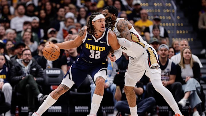 Oct 29, 2025; Denver, Colorado, USA; Denver Nuggets forward Aaron Gordon (32) controls the ball under pressure from New Orleans Pelicans guard Saddiq Bey (41) in the first quarter at Ball Arena. Mandatory Credit: Isaiah J. Downing-Imagn Images