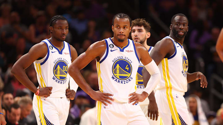Oct 25, 2022; Phoenix, Arizona, USA; Golden State Warriors guard Moses Moody (4), forward Jonathan Kuminga (00) and forward Draymond Green (23) against the Phoenix Suns at Footprint Center. Mandatory Credit: Mark J. Rebilas-Imagn Images