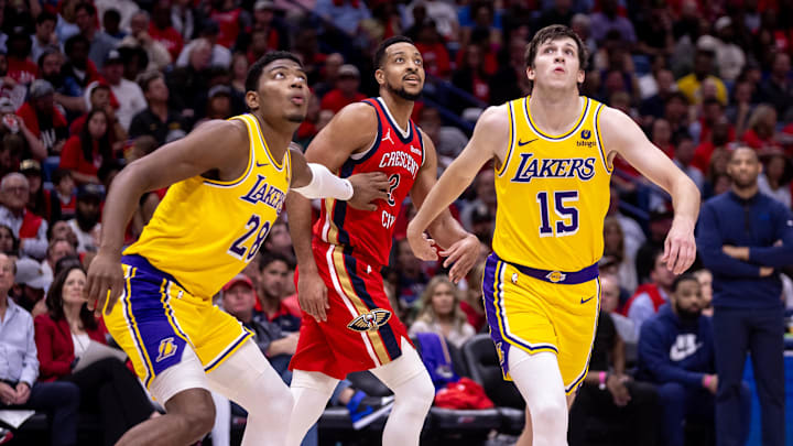 Apr 16, 2024; New Orleans, Louisiana, USA; New Orleans Pelicans guard CJ McCollum (3) is guarded from a free throw by Los Angeles Lakers guard Austin Reaves (15) and forward Rui Hachimura (28) during the first half of a play-in game of the 2024 NBA playoffs at Smoothie King Center. Mandatory Credit: Stephen Lew-Imagn Images