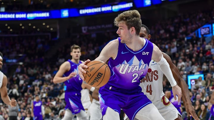 Mar 23, 2025; Salt Lake City, Utah, USA; Utah Jazz center Kyle Filipowski (22) looks to pass against Cleveland Cavaliers center Evan Mobley (4) during the first half at Delta Center. Mandatory Credit: Peter Creveling-Imagn Images