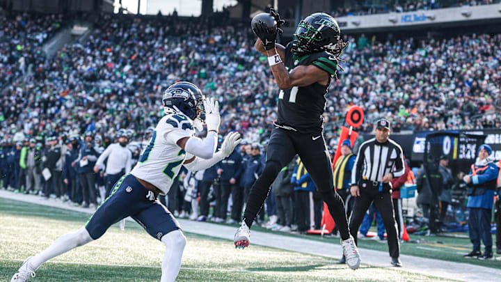 Dec 1, 2024; East Rutherford, New Jersey, USA; New York Jets wide receiver Davante Adams (17) catches a touchdown pass in front of Seattle Seahawks safety Julian Love (20) during the first quarter at MetLife Stadium. Dec 1, 2024; East Rutherford, New Jersey, USA; New York Jets wide receiver Davante Adams (17) catches a touchdown pass in front of Seattle Seahawks safety Julian Love (20) during the first quarter at MetLife Stadium.
