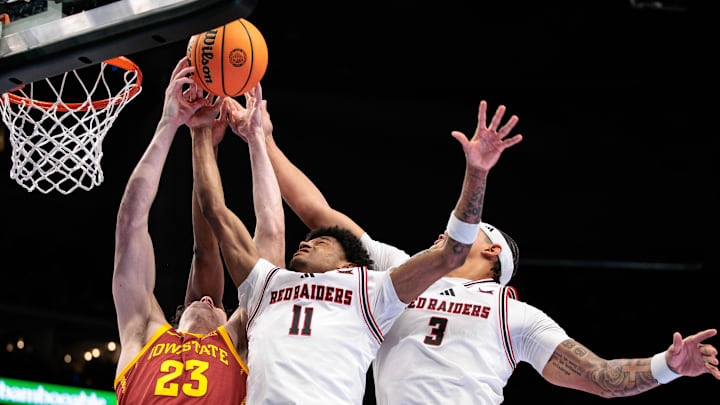 Mar 12, 2026; Kansas City, MO, USA; Iowa State Cyclones forward Blake Buchanan (23) goes after a rebound with Texas Tech Red Raiders guard Jaylen Petty (11) and Texas Tech Red Raiders guard Christian Anderson (4) during the second half at T-Mobile Center. Mandatory Credit: William Purnell-Imagn Images