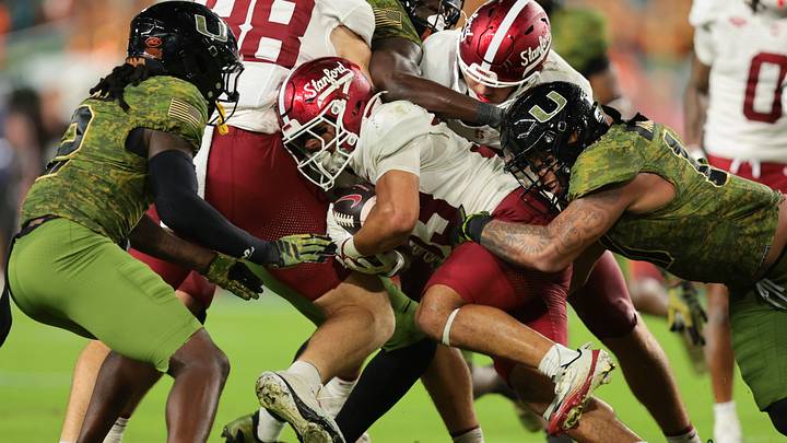 Oct 25, 2025; Miami Gardens, Florida, USA; Stanford Cardinal running back Cole Tabb (33) carries the football against Miami Hurricanes linebacker Jr. Raul Aguirre (10) during the third quarter at Hard Rock Stadium. Mandatory Credit: Sam Navarro-Imagn Images