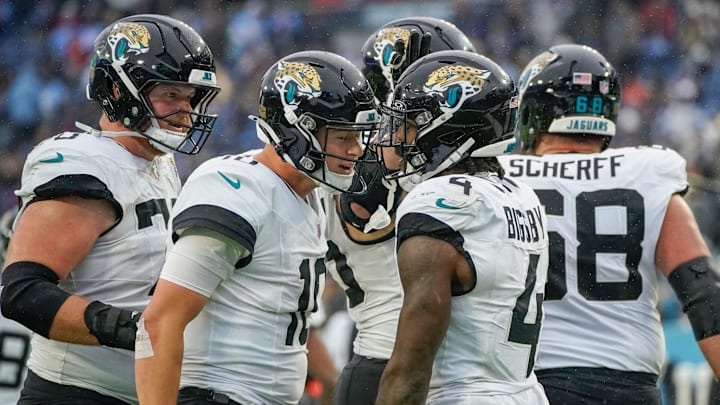 Jacksonville Jaguars quarterback Mac Jones (10) celebrates with running back Tank Bigsby (4) after Bigsby ran in a touchdown in the fourth quarter at Nissan Stadium in Nashville, Tenn., Sunday, Dec. 8, 2024.