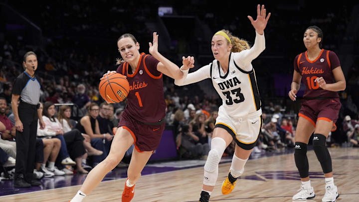 Nov 10, 2024; Charlotte, NC, USA;  Virginia Tech Hokies guard Carleigh Wenzel (1) drives to the basket against Iowa Hawkeyes guard Lucy Olsen (33) during the second half at Spectrum Center. Mandatory Credit: Jim Dedmon-Imagn Images