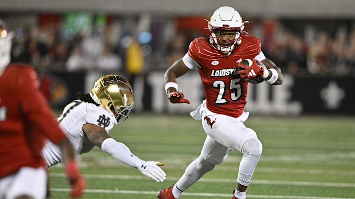 Oct 7, 2023; Louisville, Kentucky, USA;  Louisville Cardinals running back Jawhar Jordan (25) runs the ball against Notre Dame Fighting Irish safety Xavier Watts (0) during the first quarter at L&N Federal Credit Union Stadium.