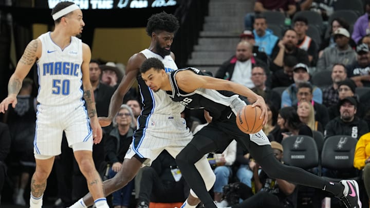 San Antonio Spurs center Victor Wembanyama (1) leans into Orlando Magic forward Jonathan Isaac (1) in the second half at Frost Bank Center.