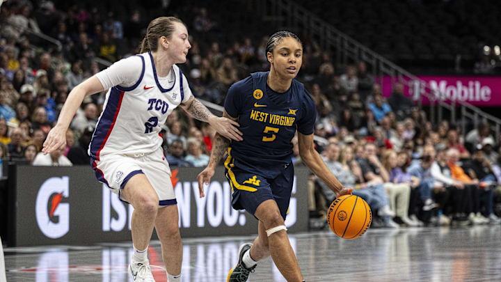 Mar 8, 2025; Kansas City, MO, USA; West Virginia Mountaineers guard Sydney Shaw (5) handles the ball while defended by TCU Horned Frogs guard Madison Conner (2) during the second half at T-Mobile Center. Mandatory Credit: Amy Kontras-Imagn Images