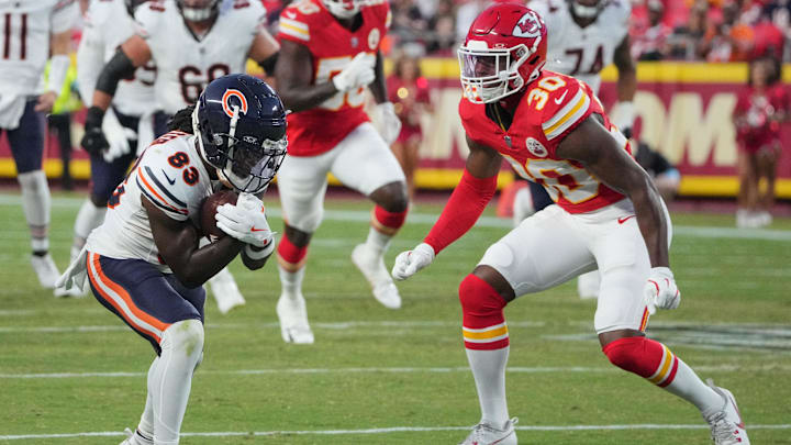 Aug 22, 2024; Kansas City, Missouri, USA; Chicago Bears wide receiver Nsimba Webster (83) runs the ball as Kansas City Chiefs cornerback Christian Roland-Wallace (30) defends during the first half at GEHA Field at Arrowhead Stadium. Mandatory Credit: Denny Medley-Imagn Images