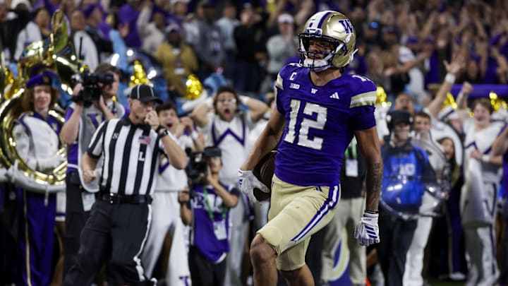 Sep 6, 2025; Seattle, Washington, USA; Washington Huskies wide receiver Denzel Boston (12) returns a punt for a touchdown against the UC Davis Aggies during the second quarter at Husky Stadium. Mandatory Credit: Joe Nicholson-Imagn Images