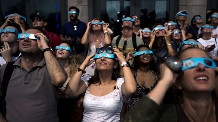 People view the solar eclipse at Rockefeller Center on August 21, 2017, in New York City.