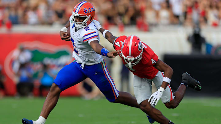 Florida Gators quarterback DJ Lagway (2) fends off Georgia Bulldogs defensive back KJ Bolden (4) during the second quarter of an NCAA college football matchup Saturday, Nov. 2, 2024 at EverBank Stadium in Jacksonville, Fla. The Georgia Bulldogs defeated the Florida Gators 34-20. [Corey Perrine/Florida Times-Union]