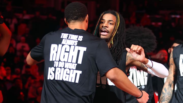 Jan 20, 2025; Memphis, Tennessee, USA; Memphis Grizzlies guard Ja Morant (right) embraces guard Desmond Bane during player introductions prior to the game against the Minnesota Timberwolves  at FedExForum. 