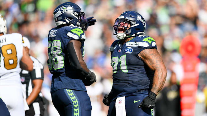 Sep 21, 2025; Seattle, Washington, USA; Seattle Seahawks defensive tackle Byron Murphy II (91) and linebacker Derick Hall (58) celebrate a sack against New Orleans Saints quarterback Spencer Rattler (2) during the third quarter at Lumen Field.