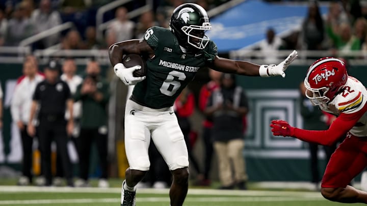 Nov 29, 2025; Detroit, Michigan, USA; Michigan State wide receiver Nick Marsh (6) stiff arms Maryland defensive back Jalen Huskey (22) in the second quarter at Ford Field. Mandatory Credit: Brendan Mullin-Imagn Images