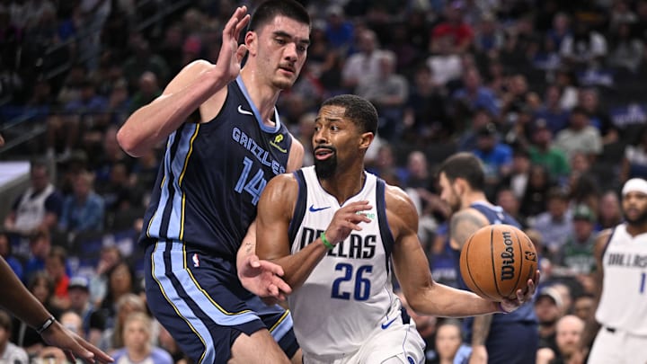 Oct 7, 2024; Dallas, Texas, USA; Dallas Mavericks guard Spencer Dinwiddie (26) drives to the basket past Memphis Grizzlies center Zach Edey (14) during the second quarter at the American Airlines Center. Mandatory Credit: Jerome Miron-Imagn Images