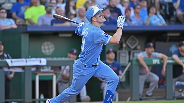 May 10, 2025; Kansas City, Missouri, USA;  Kansas City Royals left fielder Mark Canha (21) hits an RBI single in the third inning agaisnt the Boston Red Sox at Kauffman Stadium. Mandatory Credit: Peter Aiken-Imagn Images
