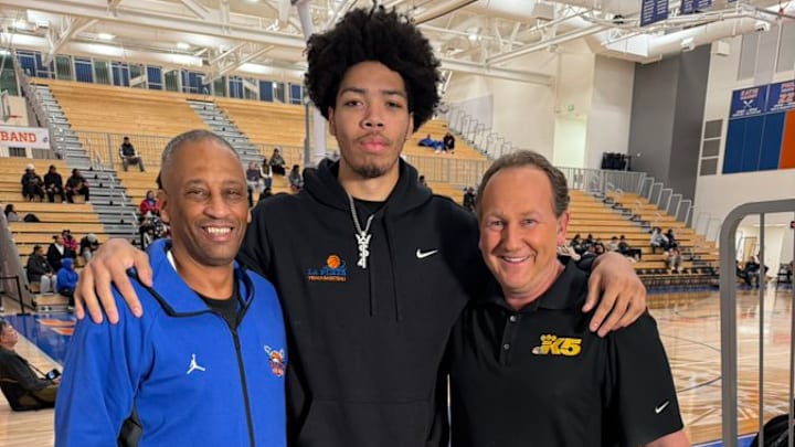 Tyran Stokes, center, poses for an image with Rainier Beach coach Mike Bethea and KING-TV's Chris Egan.