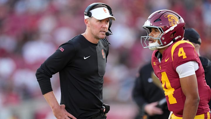 Aug 30, 2025; Los Angeles, California, USA; Southern California Trojans head coach Lincoln Riley talks with Southern California Trojans quarterback Husan Longstreet (4) in the second half against the Missouri State Bears at United Airlines Field at Los Angeles Memorial Coliseum. Mandatory Credit: Kirby Lee-Imagn Images