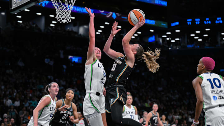 Aug 10, 2025; Brooklyn, New York, USA; New York Liberty guard Sabrina Ionescu (20) shoots against Minnesota Lynx forward Alanna Smith (8) during the first half at Barclays Center. Mandatory Credit: John Jones-Imagn Images