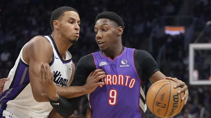 Nov 2, 2024; Toronto, Ontario, CAN; Toronto Raptors guard RJ Barrett (9) drives to th enet against Sacramento Kings forward Keegan Murray (13) during the first half at Scotiabank Arena. Mandatory Credit: John E. Sokolowski-Imagn Images