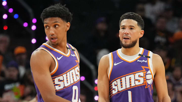 Nov 6, 2024; Phoenix, Arizona, USA; Phoenix Suns forward Ryan Dunn (0) and Phoenix Suns guard Devin Booker (1) look on against the Miami Heat during the first half at Footprint Center. Mandatory Credit: Joe Camporeale-Imagn Images Nov 6, 2024; Phoenix, Arizona, USA; Phoenix Suns forward Ryan Dunn (0) and Phoenix Suns guard Devin Booker (1) look on against the Miami Heat during the first half at Footprint Center. Mandatory Credit: Joe Camporeale-Imagn Images