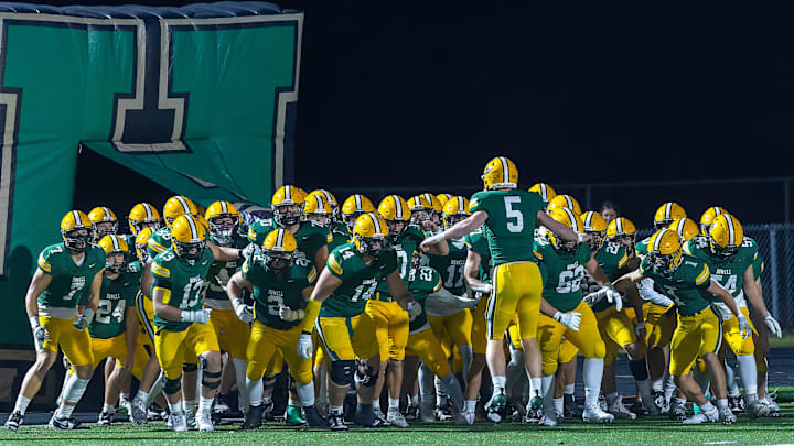 Justin Jones (5) gets his Howell Highlanders ready to take the field against Kalamazoo Central Friday, Nov. 1, 2024.