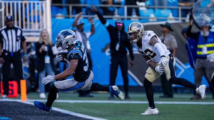 Nov 3, 2024; Charlotte, North Carolina, USA; Carolina Panthers running back Chuba Hubbard (30) scores against New Orleans Saints safety Tyrann Mathieu (32) during the fourth quarter at Bank of America Stadium. Nov 3, 2024; Charlotte, North Carolina, USA; Carolina Panthers running back Chuba Hubbard (30) scores against New Orleans Saints safety Tyrann Mathieu (32) during the fourth quarter at Bank of America Stadium.