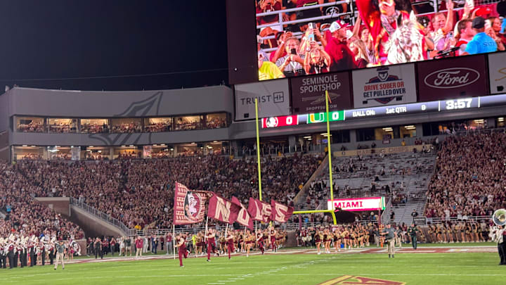 FSU's cheerleaders and football team sprint onto the field at Doak Campbell Stadium for Saturday's showdown against Miami. FSU's cheerleaders and football team sprint onto the field at Doak Campbell Stadium for Saturday's showdown against Miami.