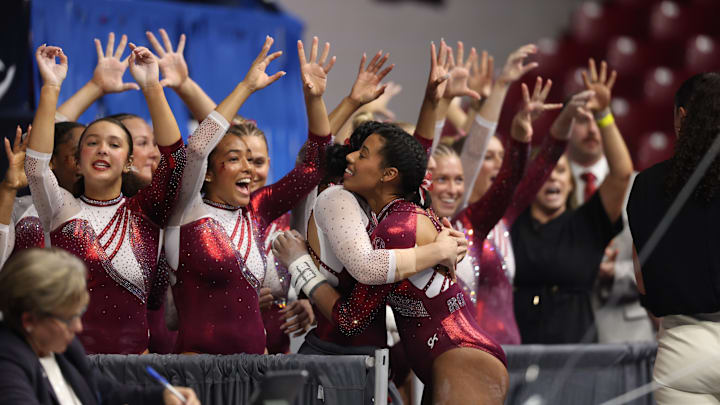 Alabama gymnastics team members celebrate.