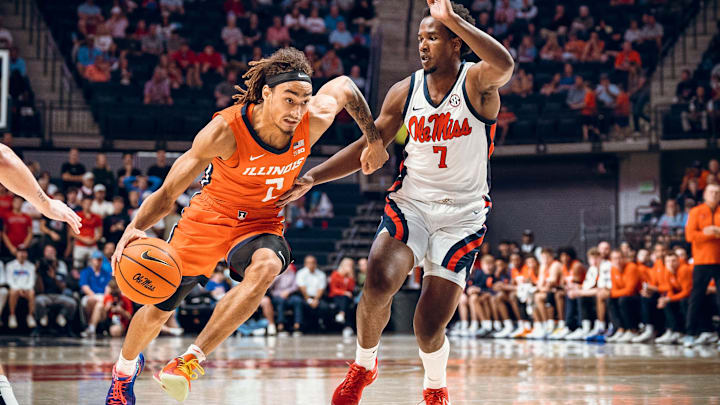Illinois guard Dra Gibbs-Lawhorn (2) drives on Ole Miss defender Davon Barnes in Sunday's charity exhibition game in Oxford, Mississippi, where the No. 24 Rebels won 91-74.