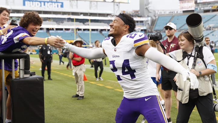 Minnesota Vikings safety Camryn Bynum celebrates a win with a fan