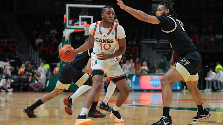 Jan 11, 2025; Coral Gables, Florida, USA; Miami Hurricanes guard Paul Djobet (10) dribbles the basketball as Wake Forest Demon Deacons forward Efton Reid III (4) defends during the first half at Watsco Center. Mandatory Credit: Sam Navarro-Imagn Images Jan 11, 2025; Coral Gables, Florida, USA; Miami Hurricanes guard Paul Djobet (10) dribbles the basketball as Wake Forest Demon Deacons forward Efton Reid III (4) defends during the first half at Watsco Center. Mandatory Credit: Sam Navarro-Imagn Images