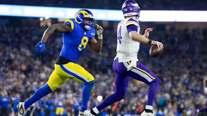 Jan 13, 2025; Glendale, AZ, USA; Minnesota Vikings quarterback Sam Darnold (14) is pursued by Los Angeles Rams linebacker Jared Verse (8) during an NFC wild card game at State Farm Stadium. Mandatory Credit: Mark J. Rebilas-Imagn Images Jan 13, 2025; Glendale, AZ, USA; Minnesota Vikings quarterback Sam Darnold (14) is pursued by Los Angeles Rams linebacker Jared Verse (8) during an NFC wild card game at State Farm Stadium. Mandatory Credit: Mark J. Rebilas-Imagn Images