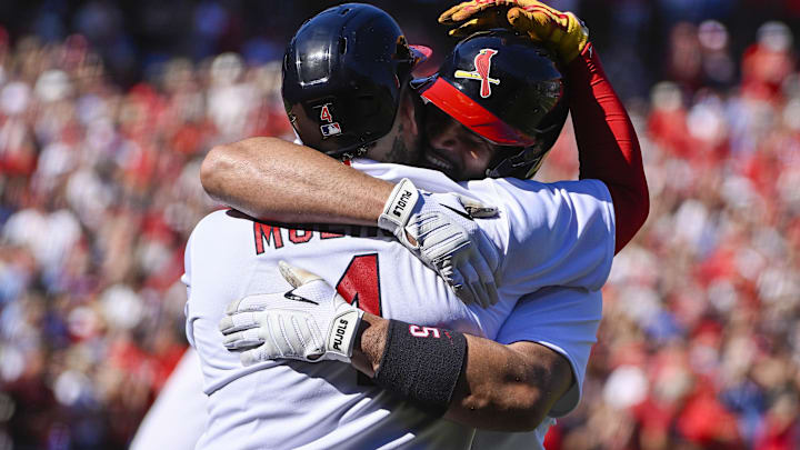 Oct 2, 2022; St. Louis, Missouri, USA;  St. Louis Cardinals first baseman Albert Pujols (5) celebrates with catcher Yadier Molina (4) after hitting a solo home run for his 702nd career home run during the third inning against the Pittsburgh Pirates at Busch Stadium. Mandatory Credit: Jeff Curry-Imagn Images