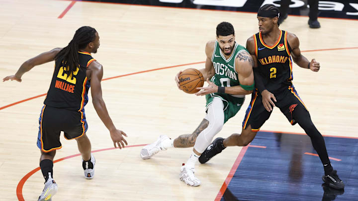 Jan 5, 2025; Oklahoma City, Oklahoma, USA: Boston Celtics forward Jayson Tatum (0) drives to the basket against Oklahoma City Thunder guard Shai Gilgeous-Alexander (2) during the third quarter at Paycom Center. Mandatory Credit: Alonzo Adams-Imagn Images