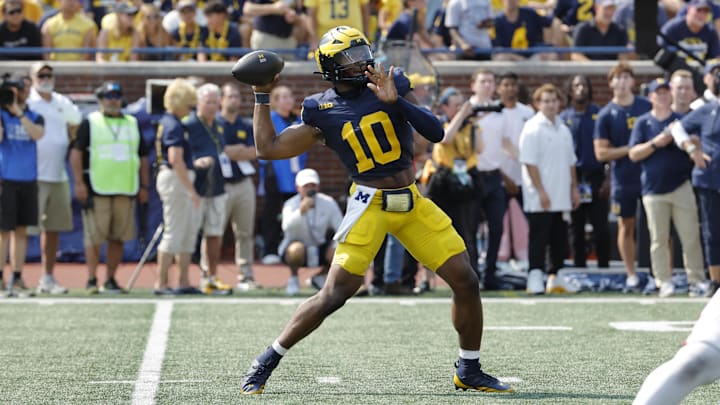 Sep 14, 2024; Ann Arbor, Michigan, USA;  Michigan Wolverines quarterback Alex Orji (10) passes second half against the Arkansas State Red Wolves at Michigan Stadium. Mandatory Credit: Rick Osentoski-Imagn Images