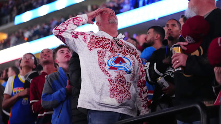 Jan 16, 2026; Denver, Colorado, USA; Colorado Avalanche fan salutes before the game against the Nashville Predators at Ball Arena. Mandatory Credit: Ron Chenoy-Imagn Images