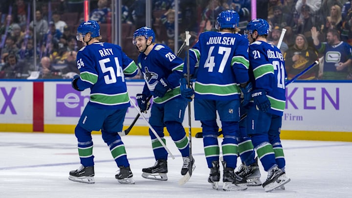 Nov 17, 2024; Vancouver, British Columbia, CAN; Vancouver Canucks forward Aatu Raty (54) and defenseman Erik Brannstrom (26) and defenseman Noah Juulsen (47) and forward Nils Hoglander (21) celebrate Brannstrom’s goal against the Nashville Predators during the first period at Rogers Arena. Mandatory Credit: Bob Frid-Imagn Images
