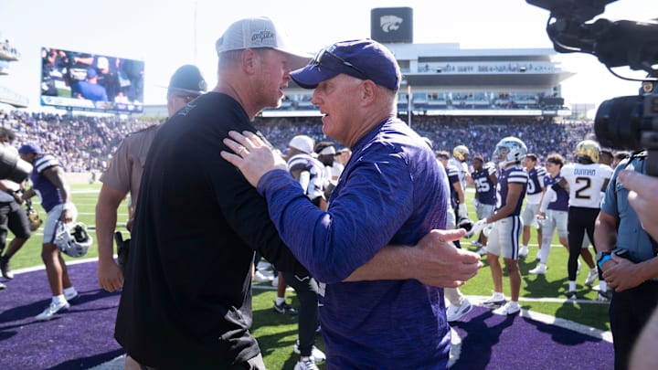 Kansas State Wildcats head coach Chris Klieman meets with UCF Knights head coach Scott Frost after the game against UCF Knights at Bill Snyder Family Stadium on Sept. 27, 2025.