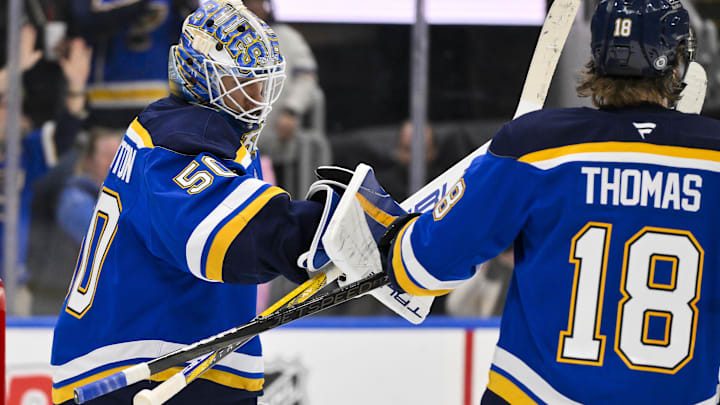 Feb 23, 2025; St. Louis, Missouri, USA;  St. Louis Blues goaltender Jordan Binnington (50) celebrates with center Robert Thomas (18) after the Blues defeated the Colorado Avalanche at Enterprise Center. Mandatory Credit: Jeff Curry-Imagn Images