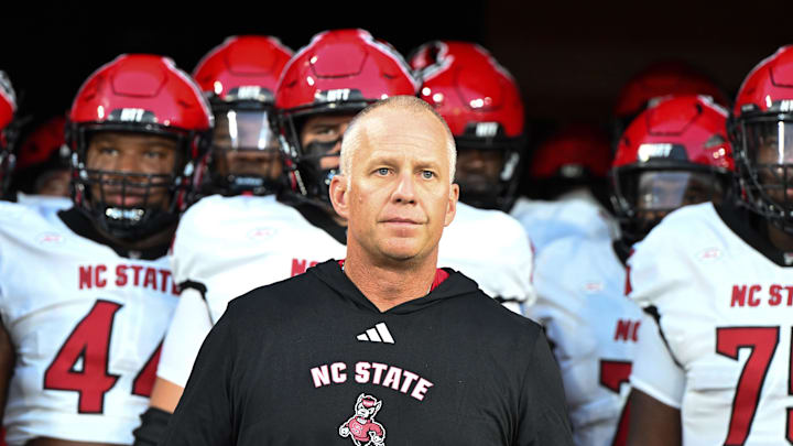 Sep 11, 2025; Winston-Salem, North Carolina, USA;  North Carolina State Wolfpack head coach Dave Doeren walks his team out on the field against the Wake Forest Demon Deacons at Allegacy Federal Credit Union Stadium. Mandatory Credit: Luke Jamroz-Imagn Images