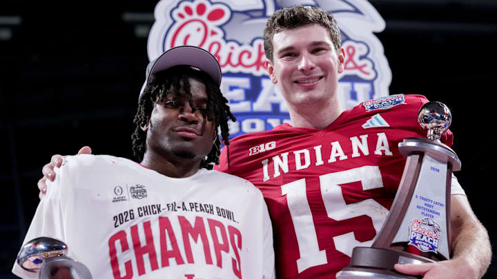 Indiana Hoosiers defensive back D'Angelo Ponds (5) and Indiana Hoosiers quarterback Fernando Mendoza (15) pose for photographs Friday, Jan. 9, 2026, after defeating the Oregon Ducks in the Peach Bowl and semifinal game of the College Football Playoff at Mercedes-Benz Stadium in Atlanta.