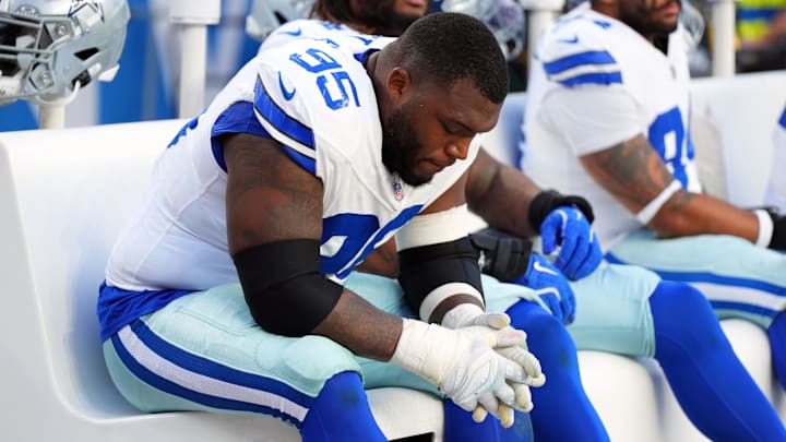 Dallas Cowboys defensive tackle Kenny Clark (95) reacts on the bench in the second half against the Denver Broncos at Empower Field at Mile High.