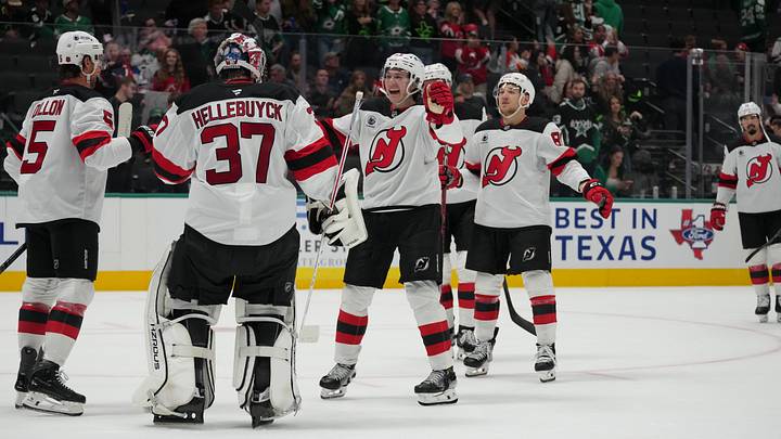 Brenden Dillon, Connor Hellebuyck, Nico Hischier, and Arseny Gritsyuk celebrate a New Jersey Devils win Brenden Dillon, Connor Hellebuyck, Nico Hischier, and Arseny Gritsyuk celebrate a New Jersey Devils win
