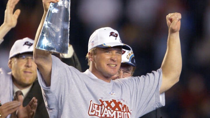 Tampa Bay Buccaneers head coach Jon Gruden holds up the Vince Lombardi Trophy after winning Super Bowl XXXVIII.