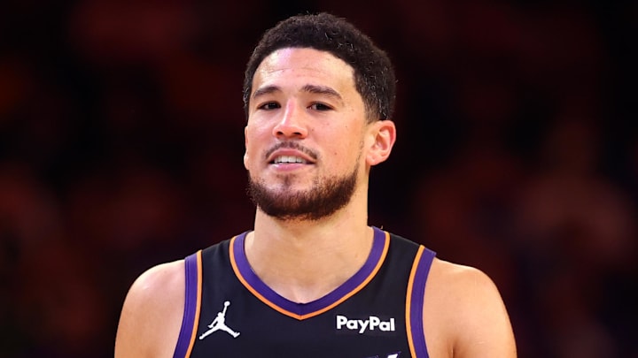 Apr 17, 2026; Phoenix, Arizona, USA; Phoenix Suns guard Devin Booker (1) against the Golden State Warriors during the play-in rounds of the 2026 NBA Playoffs at Mortgage Matchup Center. Mandatory Credit: Mark J. Rebilas-Imagn Images