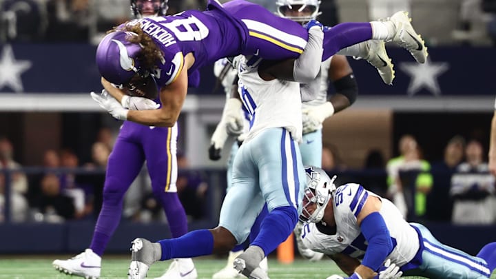 Dallas Cowboys linebacker Demarvion Overshown tackles Minnesota Vikings tight end T.J. Hockenson.