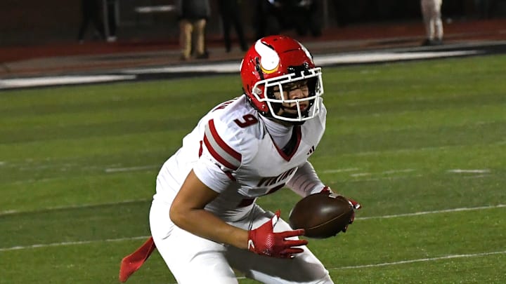 Landen Miree takes in a completed pass for Princeton in the OHSAA Division I football regional semifinals Nov. 15, 2024, at Dwire Field Mason, Ohio.